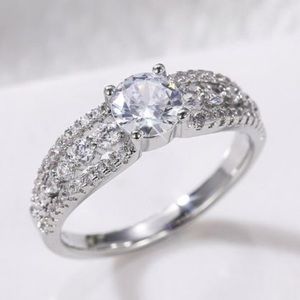 Beautiful and dainty CZ ring solitaire surrounded with pave stones